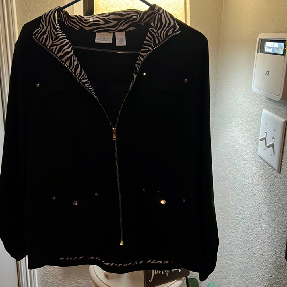 This beautiful lightly worn jacket with zebra stripes to the sleeves and collar